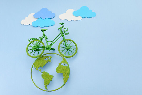 World bicycle day. Green bicycle riding a clean energy path on planet earth
