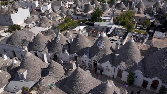 Traditional Trulli Rooftops, Aerial Shot of Unique Conical Roofed Houses of Alberobello in Puglia, Italy. Sunny Day.