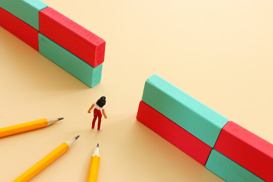 Woman figure finding gap in obstacle. Concept of education and challenge