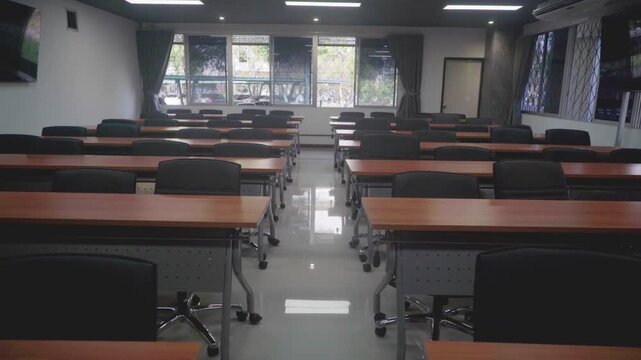 Contemporary office conference room interior featuring an empty wooden meeting table and business chairs in a professional workspace design