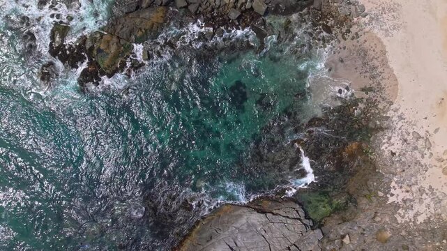 Aerial top down hidden beach Punta Pite coastline in Valparaiso Chile drone fly ocean bay, nature landscape