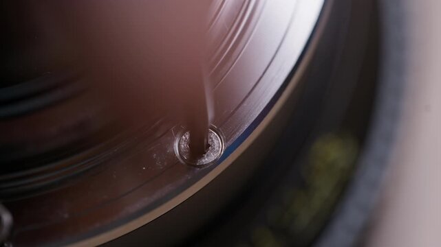 Extreme macro close-up of a Torx screw being removed from a cinema lens mount during EF to PL conversion. Screw head and tool clearly visible. Highly detailed technical footage.