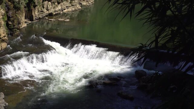 A fast-flowing river flows between two mountains in Mizoram
