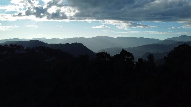 The light of the sunset has created parallel lines on the hills.