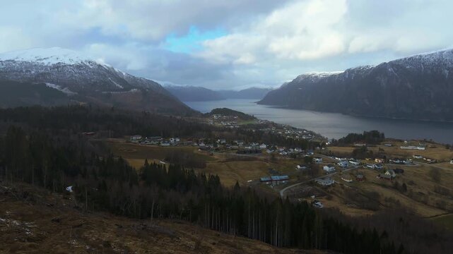 Scenic drone shot of Stranda, a small town in Norway that lies with a fjord and is surrounded by mountains and beautiful scenery
