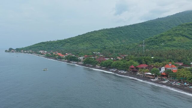 Aerial view of amed bali black sand beach coastline