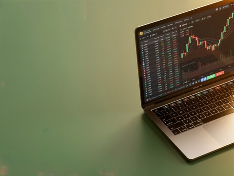 Cryptocurrency trading dashboard on a laptop