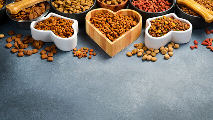 Naklejka na ściany i meble Dry pet food with natural ingredients. Raw meat in a bowl for pets. A set of different fodder and food for dogs or cats.