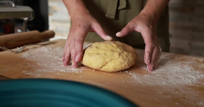 Woman preparing dough for homemade tagliatelle pasta indoor - Food, italian culture and lifestyle concept 