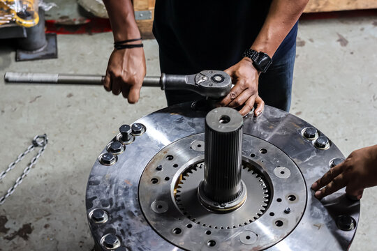 Technician Tightening Bolts Using Large Industrial Ratchet