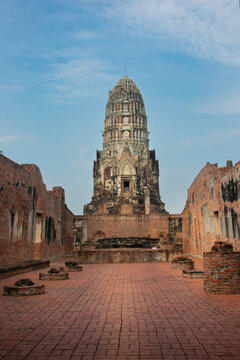 Ancient red‑brick temple ruin with tall central prang