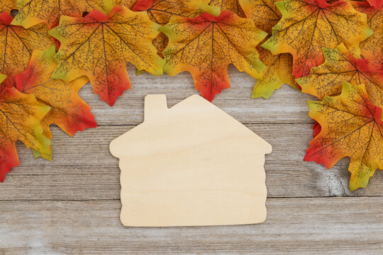 Autumn leaves frame with wooden house shape