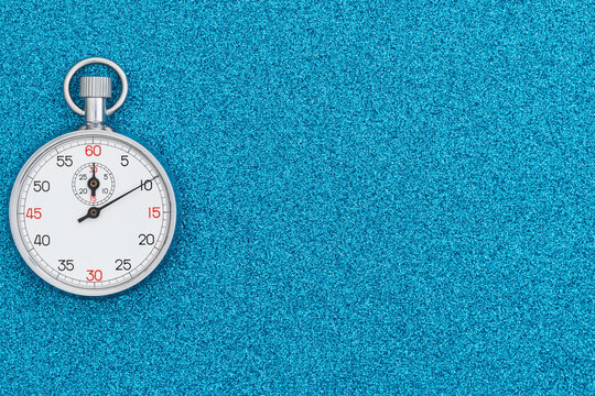 Stopwatch on blue textured background with copy space