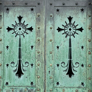 Turquoise metal doors with black ornamental motifs