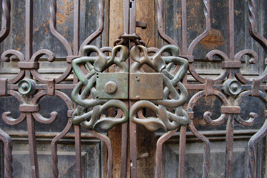 Rusted iron gate with ornate central knot detail