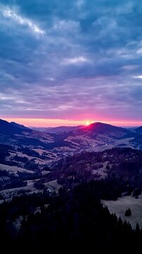 Vertical Aerial Hyperlapse of Colorful Sunset Over Mountain Ridges