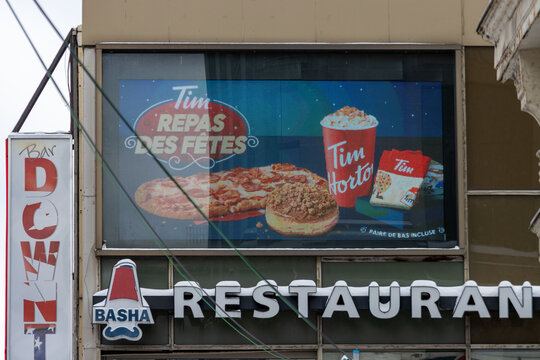 MONTREAL, CANADA, 25 December 2025 : Bar Down, Tim Hortons, Basha, restaurant marquee, holiday meal advertisement