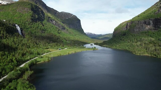 Espelandsvatnet lake with road through mountain valley near Ulvik Hardanger Norway green landscape