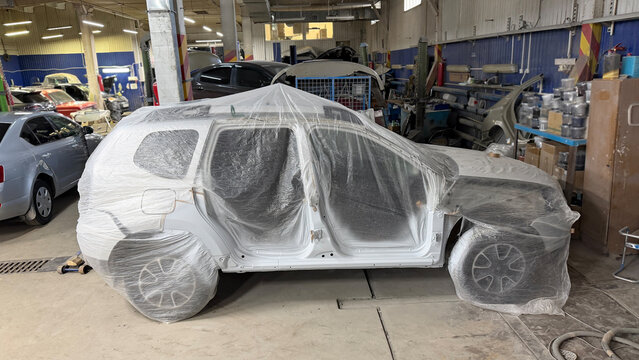 Wrapped car in repair shop ready for painting