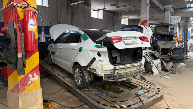 Auto repair workshop with damaged car body
