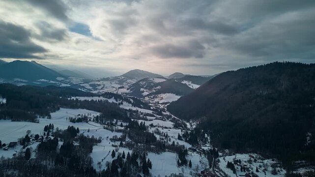 Aerial View Orbiting Over Winter Mountains with Moving Clouds