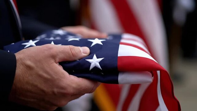 Close up of Hands Holding a Folded American Flag at a Memorial Service