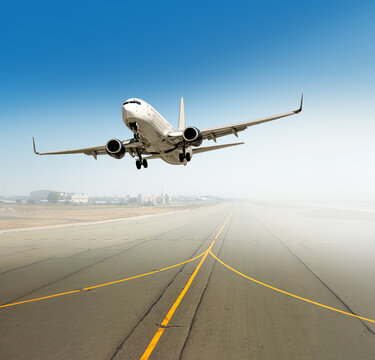 Airplane taking off from a dusty airport runway
