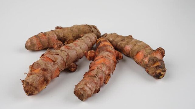 Handheld Shot of Turmeric Isolated on White Background