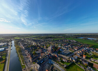 Obraz premium Aerial view of Rijkevorsel village, België showing residential neighborhoods, canal and surrounding farmland from above