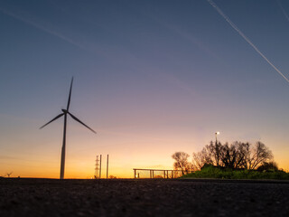 Obraz premium Wind turbine at sunset in rural landscape, Halle, België - renewable energy and sustainable power generation concept
