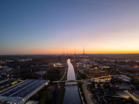Aerial view of industrial canal and port facilities at sunset in Vlaams-Brabant, Belgium