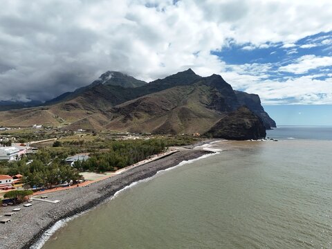 Aerial drone view of dramatic coastal landscape and mountain range in Western Gran Canaria