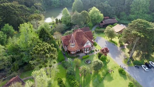 Aerial drone view of European style chalet house with red roof and garden in Gramado southern Brazil