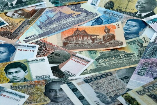 Cambodian riel money banknotes pile on table. Cambodia bills of KHR currency close up