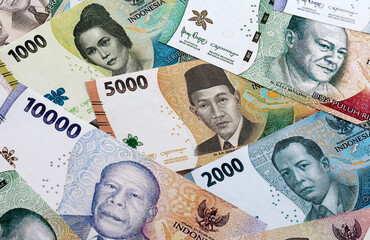 Indonesian rupiah money banknotes pile on table. Indonesia bills of IDR currency close up © Larysa