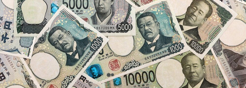 Japanese yen money banknotes pile on table. Japan bills of JPY currency. Concept of economy