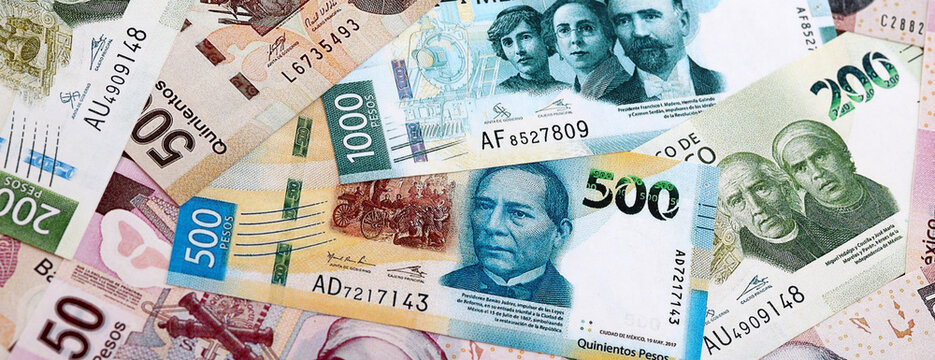 Mexican peso money banknotes pile on table. Mexico bills of MXN currency close up