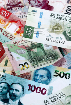 Mexican peso money banknotes pile on table. Mexico bills of MXN currency close up