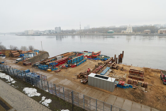 Empty winter storage yard beside river with safety inspector audit