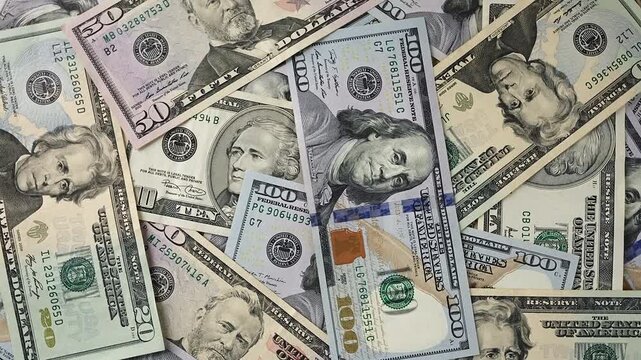 Financial background featuring pile mixed American Dollar bills. High angle shot cash banknotes. Concept monetary savings, banking, economic prosperity. Professional wealth management investment foota