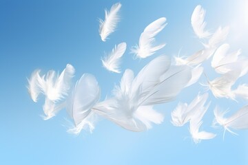 Naklejka premium White feathers gently floating and scattering against a clear blue sky background