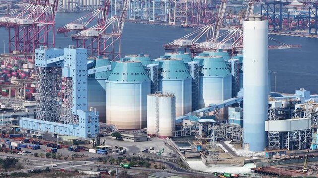 Industrial silos and cranes operating at a commercial seaport