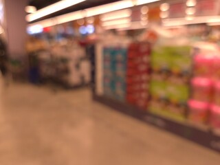 Fototapeta premium Blurred Supermarket Interior Background with Bokeh Lights and Copy Space