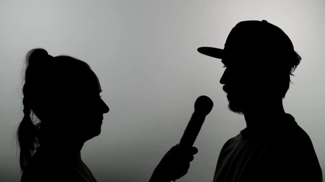 An anonymous interview, a woman's silhouette asks a man questions without revealing his identity