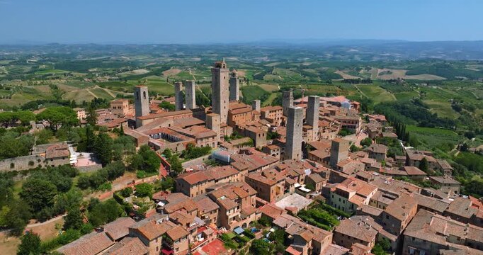 Aerial drone view historic town of Orte, Italy, during summer day. Panorama traditional stone buildings with red-tiled roofs nestled in lush green landscape Lazio region.