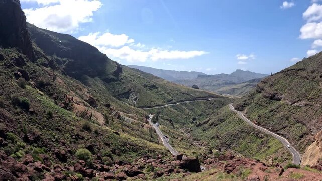 POV walking shot of Los Azulejos rainbow rocks and expansive mountain valley Gran Canaria
