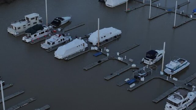 Aerial view of boats nestled in the marina, showcasing a blend of covered and uncovered vessels along the docks, Dayton, Kentucky, United States.