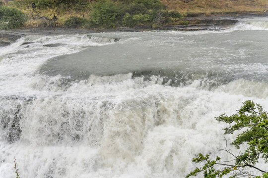 whirling falling waters at Paine river waterfall, Magallanes, Chile