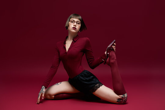 Young fashionable woman showcases stunning style in bold poses against a vibrant backdrop