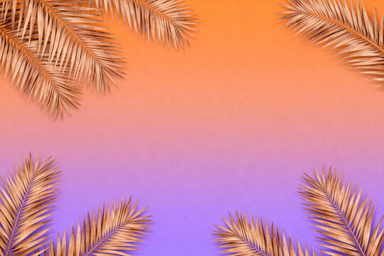 Palm tree leaves, on a gradient orange and purple background. Copy space, summer background.